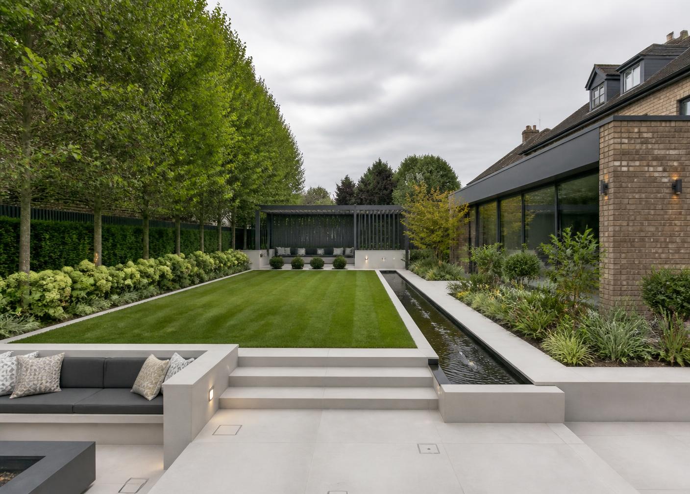 A contemporary Surrey garden with a water rill and level lawn